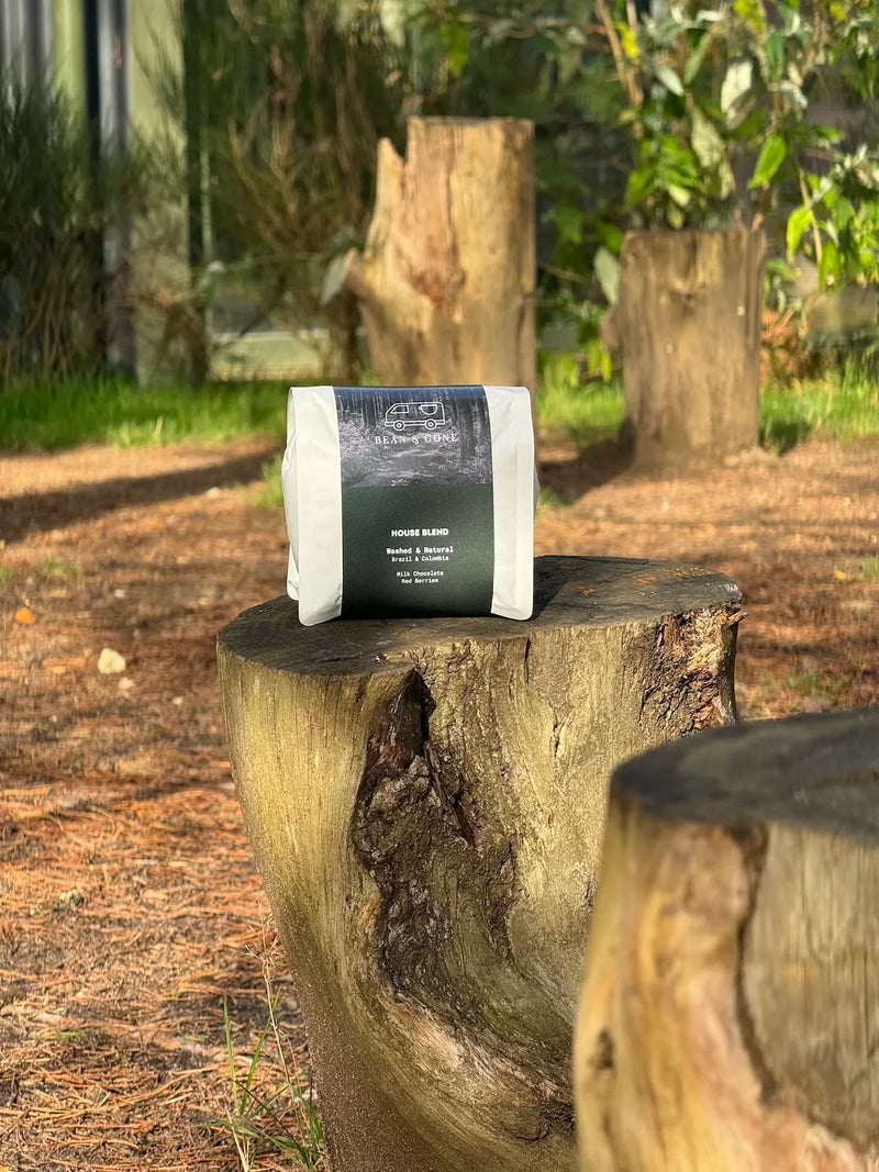 Coffee bag on a wooden log with a natural outdoor background